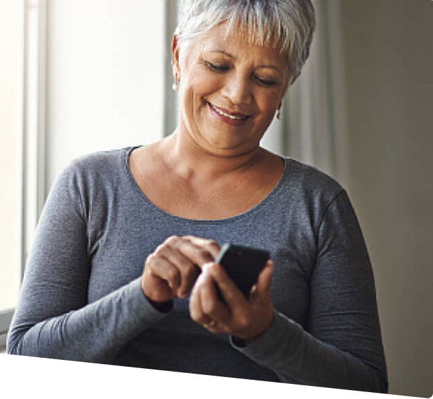 A lady accessing more than one account via mobile with smiling face